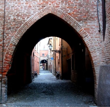 Gothic arch at the entry to one of the old city's streets, Ferrara, Italy
